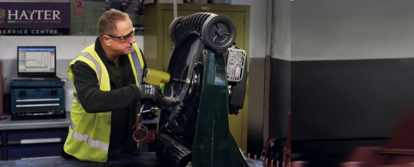 A Man Repairing a Hayter Mower 