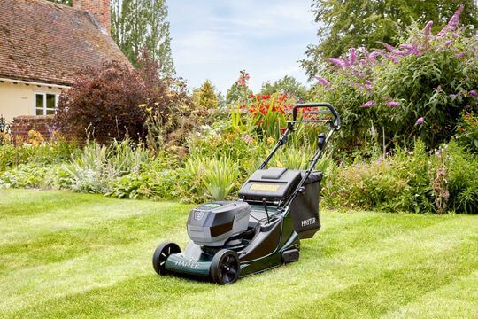 Battery lawnmower on a freshly cut lawn