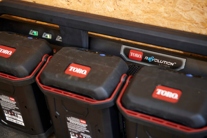 Top view of Toro Flex-Force batteries connected to the 6-Pod Charger showing LED status lights