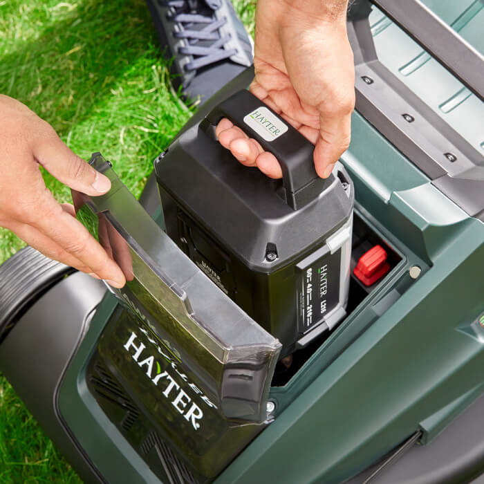 Battery being inserted into Hawk 43 lawnmower